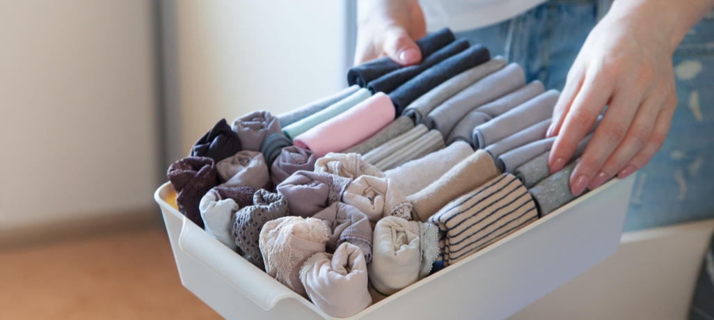 clothes organized in bin